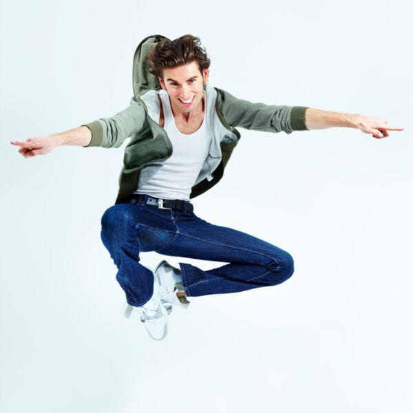 Airborne fun. Portrait of a young man leaping up and posing while in the air. Airborne fun. Portrait of a young man leaping up and posing while in the air.