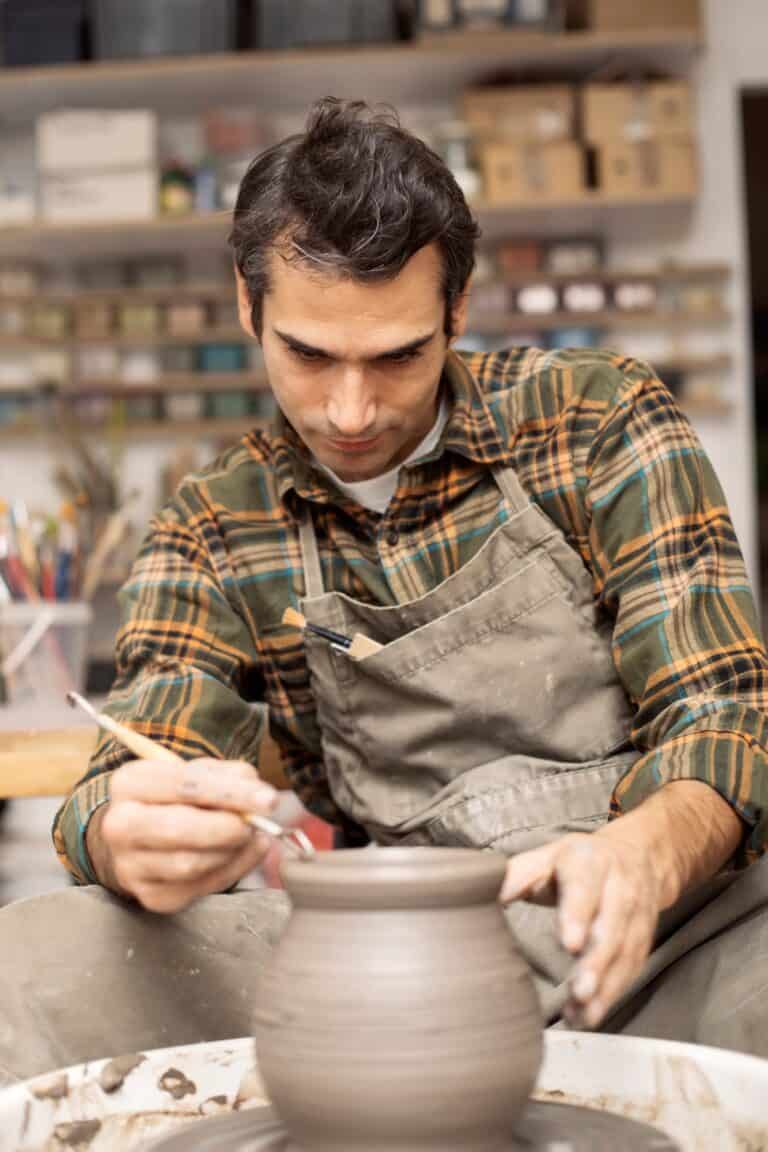 Artist makes clay pottery on a spin wheel