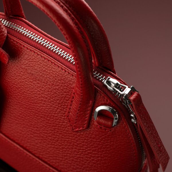 Closeup shot of a luxury red leather bag Closeup shot of a luxury red leather bag