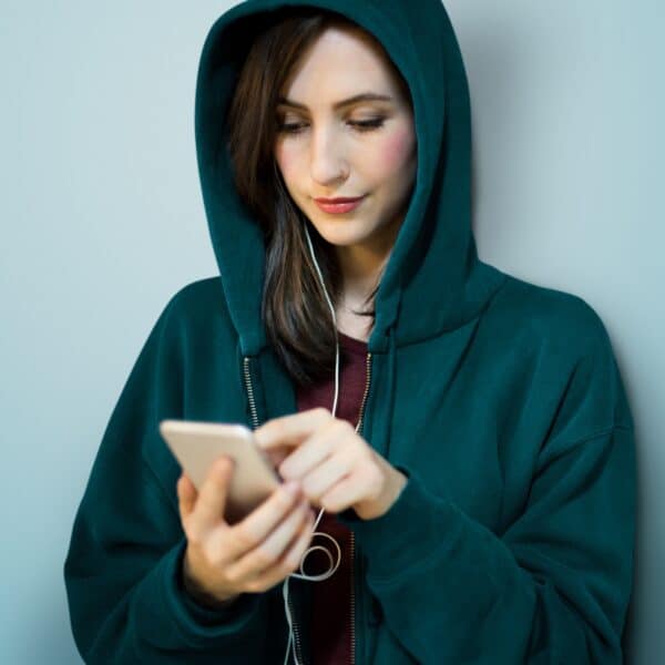 Girl Hoodie Listening Music Phone Concept Girl Hoodie Listening Music Phone Concept