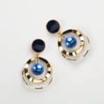 Golden round earrings with blue beads in them Golden round earrings with blue beads in them