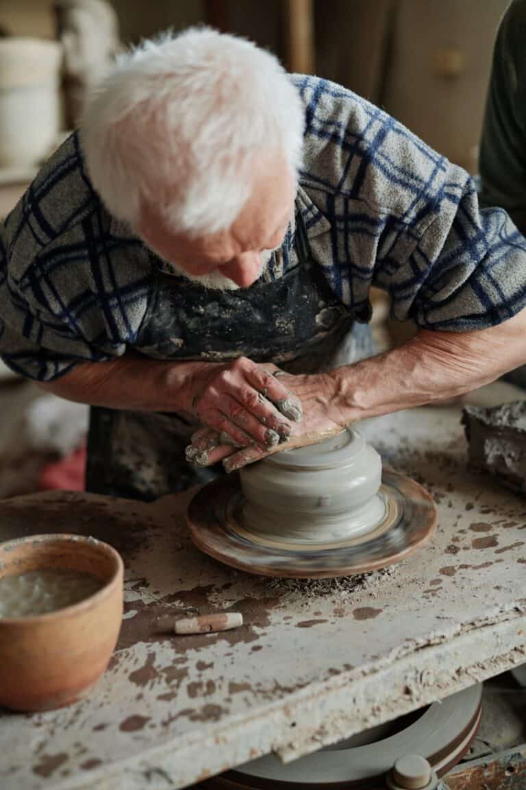 Potter modeling vase on pottery wheel