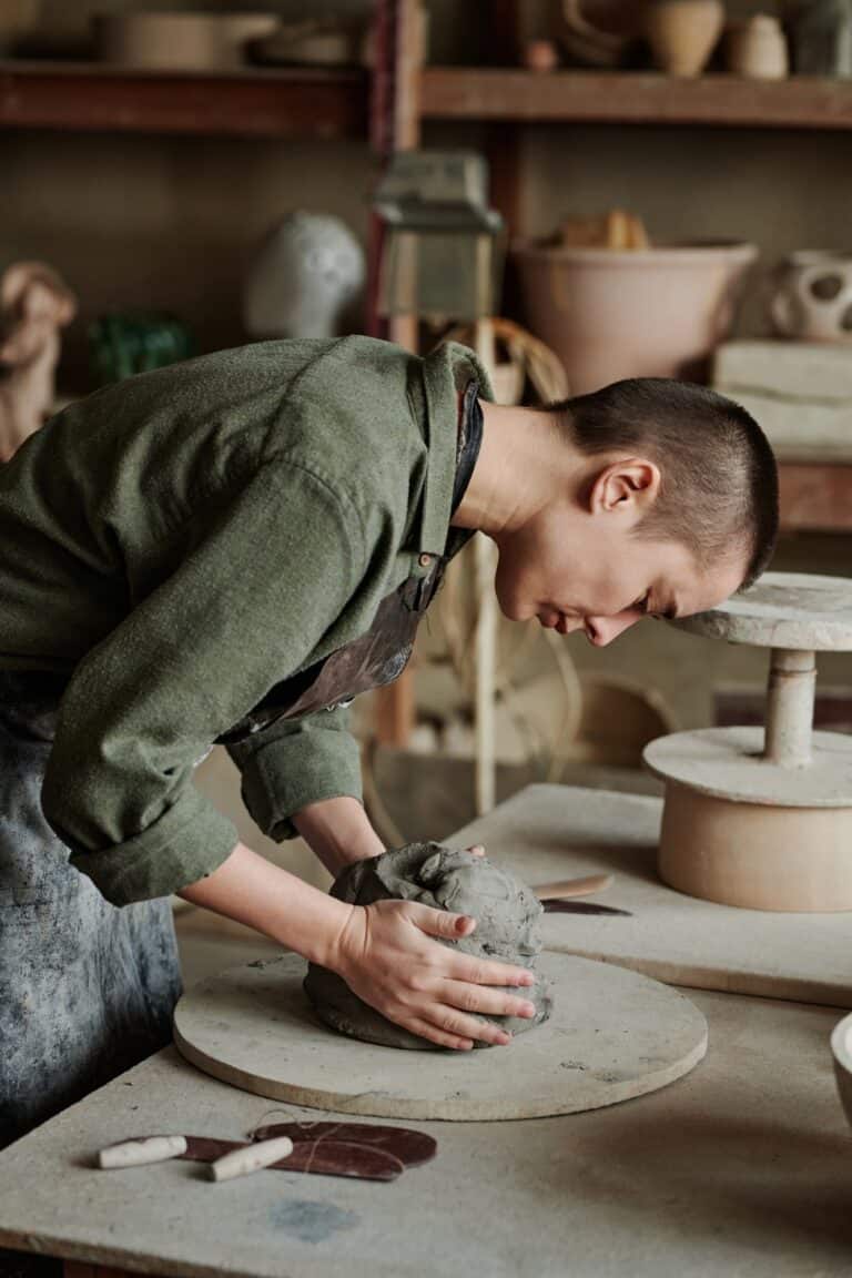 Woman making ceramic sculptures in workshop